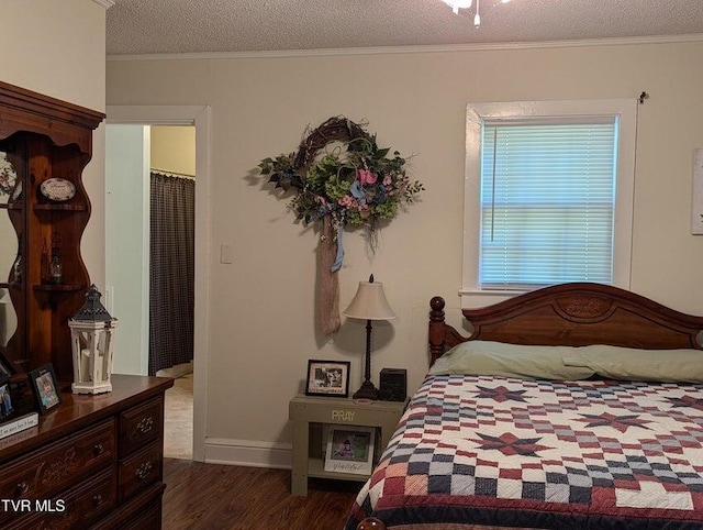 bedroom with crown molding, dark hardwood / wood-style flooring, and a textured ceiling