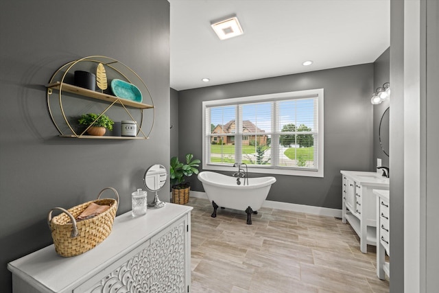 bathroom featuring a tub and vanity