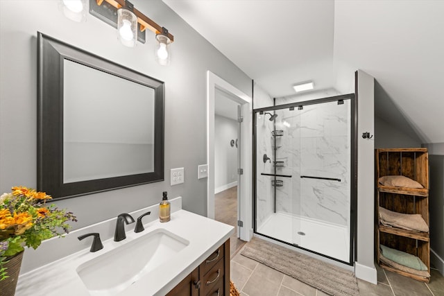 bathroom with tile patterned flooring, vanity, and walk in shower