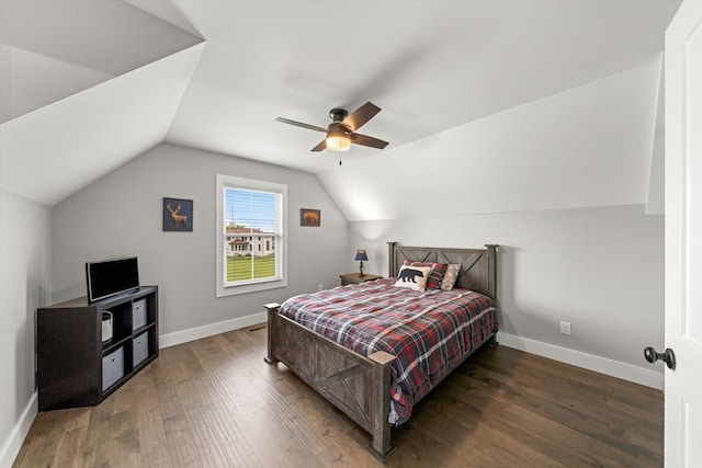 bedroom with ceiling fan, dark wood-type flooring, and lofted ceiling