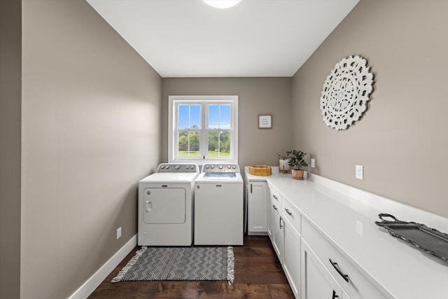 laundry area with washer and clothes dryer, cabinets, and dark wood-type flooring