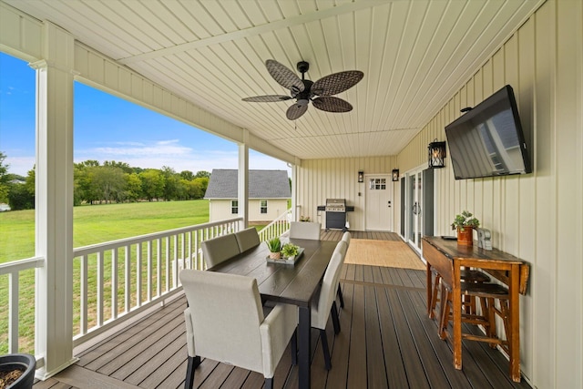 wooden deck with a lawn, ceiling fan, and area for grilling