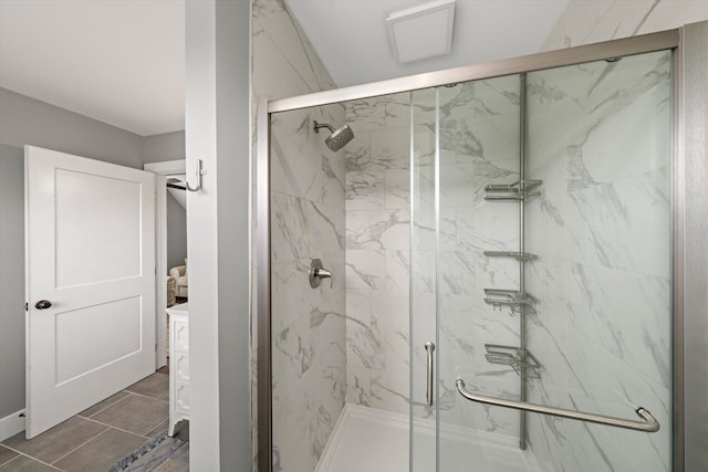 bathroom with tile patterned floors and a shower with door