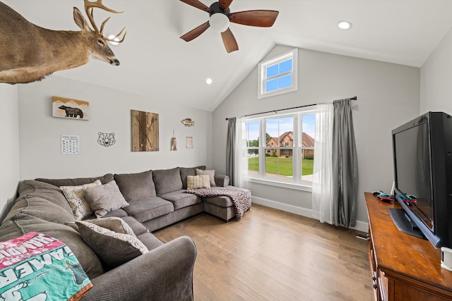 living room with hardwood / wood-style floors, vaulted ceiling, and ceiling fan