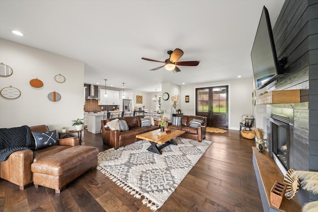 living room featuring dark hardwood / wood-style floors and ceiling fan