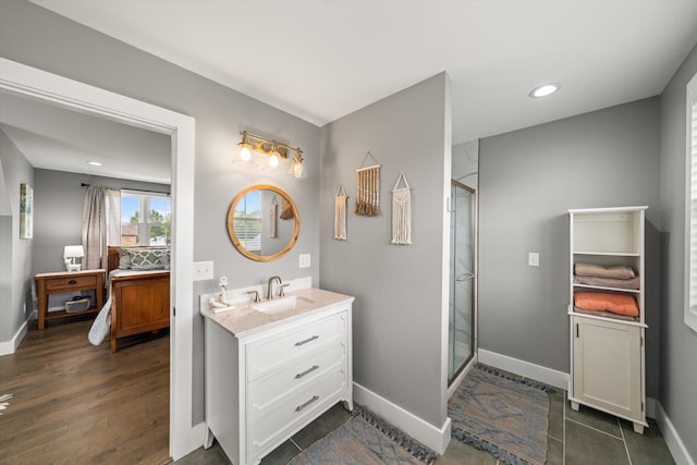 bathroom featuring tile patterned flooring, vanity, and an enclosed shower