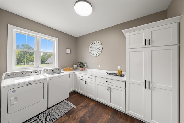 laundry room with washing machine and dryer, dark hardwood / wood-style flooring, and cabinets