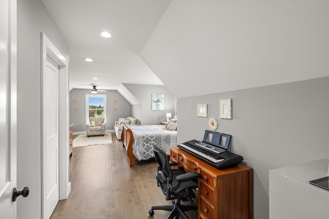 bedroom with hardwood / wood-style floors and vaulted ceiling