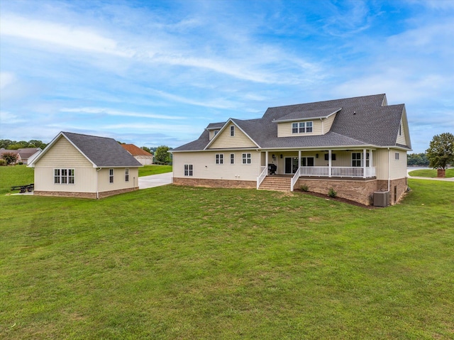 back of house with a lawn and covered porch