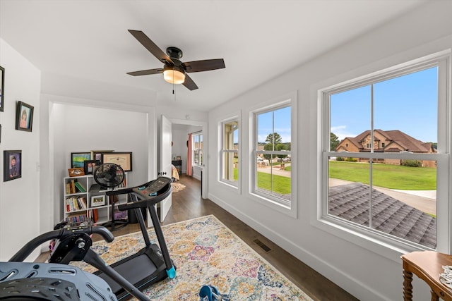 exercise room featuring dark hardwood / wood-style floors and ceiling fan