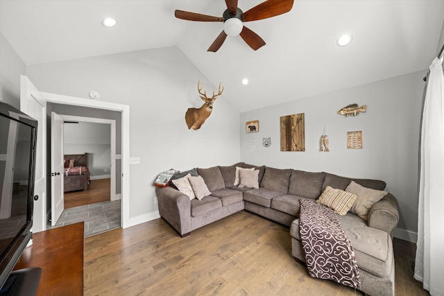 living room with light wood-type flooring, vaulted ceiling, and ceiling fan