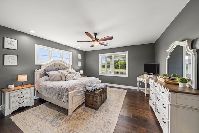 bedroom with dark hardwood / wood-style flooring and ceiling fan