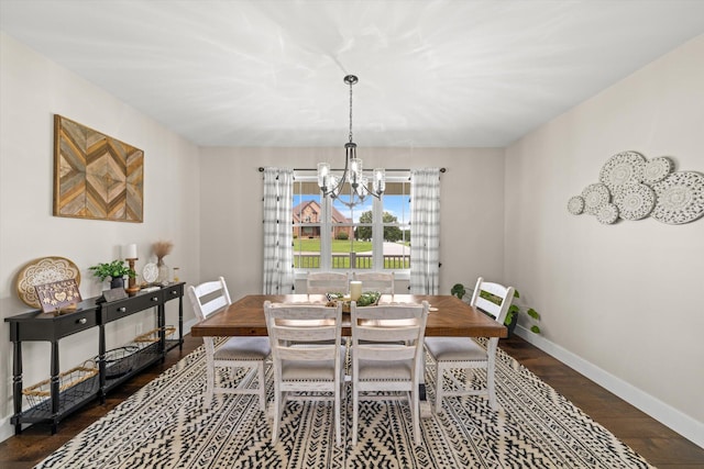 dining room featuring dark hardwood / wood-style flooring and a chandelier