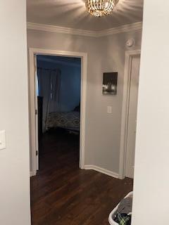 2115 Eastview Ave, Jefferson City, TN 37760 - hallway featuring crown molding, dark wood-type flooring, and an inviting chandelier