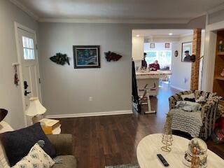 2115 Eastview Ave, Jefferson City, TN 37760 - living room featuring crown molding and dark hardwood / wood-style flooring