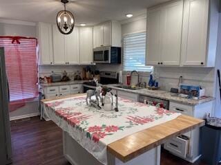 2115 Eastview Ave, Jefferson City, TN 37760 - kitchen with stainless steel appliances, white cabinets, a kitchen island, hanging light fixtures, and butcher block counters