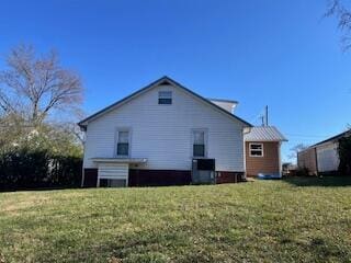 2115 Eastview Ave, Jefferson City, TN 37760 - rear view of house with a lawn and cooling unit
