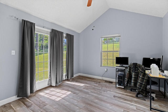 home office with a ceiling fan, baseboards, vaulted ceiling, and wood finished floors