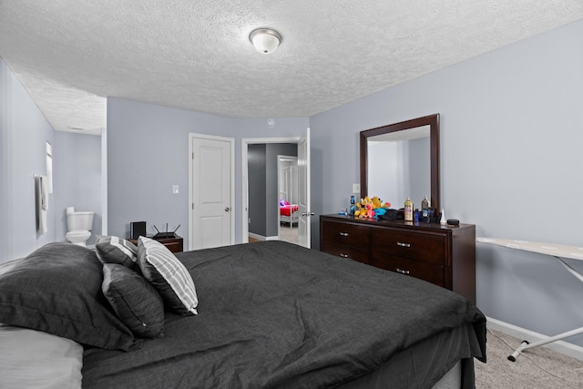 bedroom featuring carpet floors, a textured ceiling, and baseboards