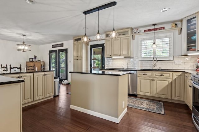 1626 Cardinal Dr, Morristown, TN 37814 - kitchen featuring dark wood-style flooring, dark countertops, a sink, cream cabinetry, and stainless steel dishwasher