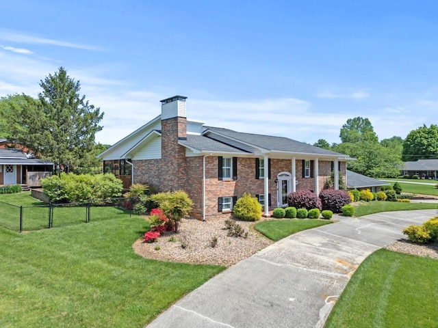 1626 Cardinal Dr, Morristown, TN 37814 - bi-level home with fence, roof with shingles, brick siding, a front yard, and a chimney