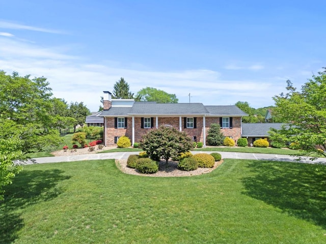 1626 Cardinal Dr, Morristown, TN 37814 - view of front of home featuring brick siding, a front lawn, driveway, and a chimney