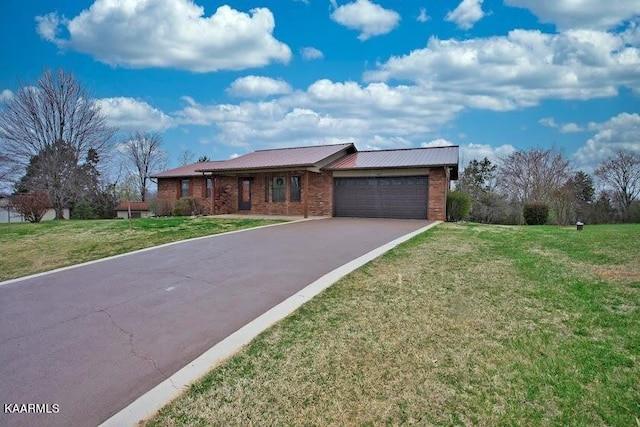 view of front of property with a garage and a front lawn