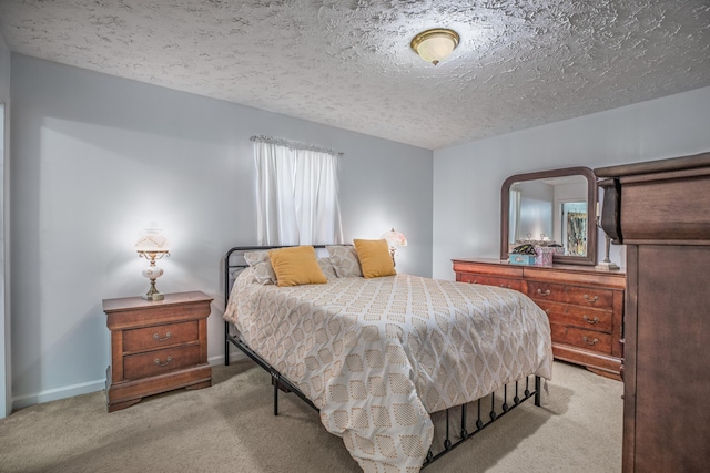 bedroom with carpet and a textured ceiling