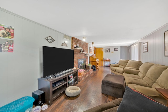 living room featuring a fireplace, hardwood / wood-style floors, and wood walls