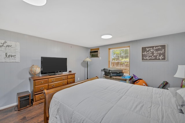 bedroom featuring a wall mounted air conditioner and wood-type flooring