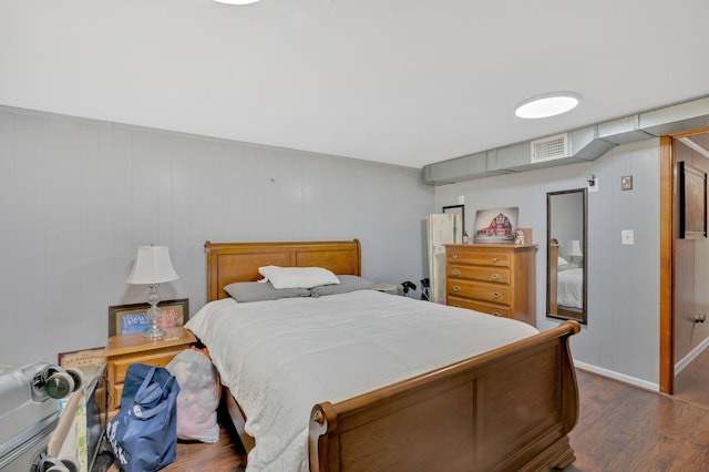 bedroom with dark wood-type flooring