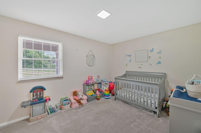 carpeted bedroom with a nursery area