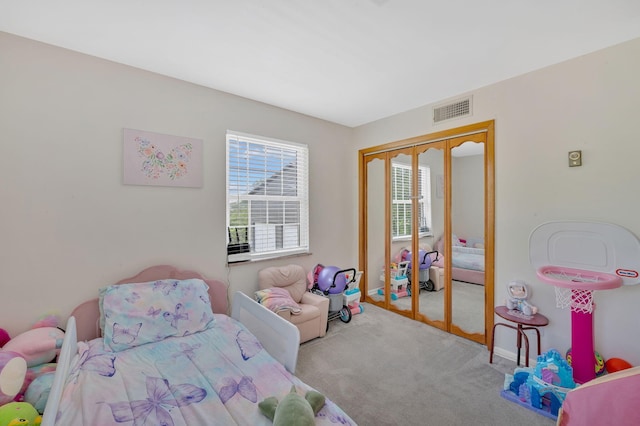 carpeted bedroom featuring a closet