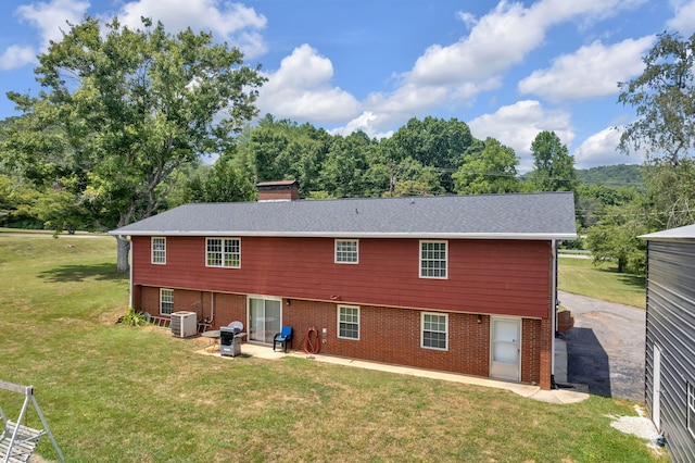 back of property featuring a yard, a patio, and central AC unit