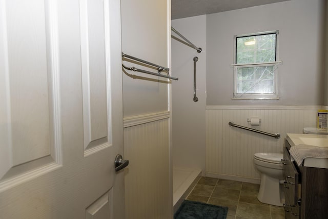 3084 Sherm Mountain Rd, Sneedville, TN 37869 - bathroom featuring a wainscoted wall, a shower stall, vanity, toilet, and tile patterned floors