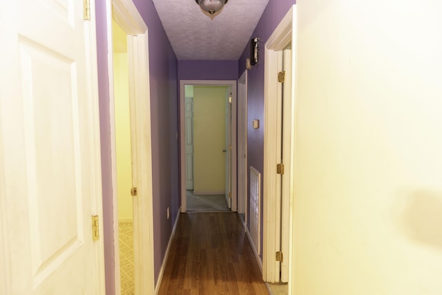 3084 Sherm Mountain Rd, Sneedville, TN 37869 - hall featuring dark wood-style floors, a textured ceiling, and baseboards