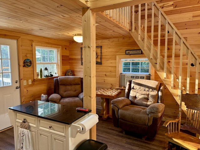 living area featuring cooling unit, dark hardwood / wood-style flooring, wood ceiling, and wooden walls