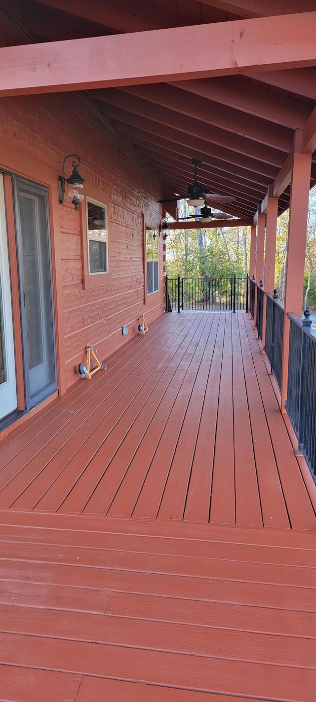 wooden terrace featuring a porch and ceiling fan