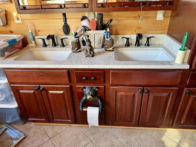 bathroom featuring tile patterned floors, wood walls, and vanity