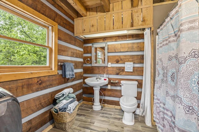 7868 Saint Clair Rd, Whitesburg, TN 37891 - bathroom with toilet, wood finished floors, wooden walls, a shower with curtain, and a sink
