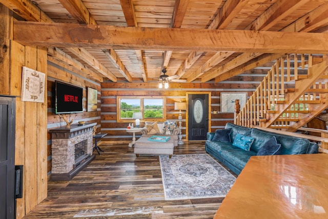 7868 Saint Clair Rd, Whitesburg, TN 37891 - living room with wood ceiling with exposed beams, wooden walls, wood-type flooring, a ceiling fan, and a fireplace with raised hearth