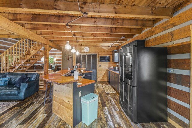7868 Saint Clair Rd, Whitesburg, TN 37891 - kitchen with appliances with stainless steel finishes, dark wood-type flooring, wooden walls, wooden ceiling with exposed beams, and pendant lighting