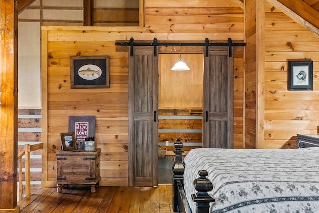 7868 Saint Clair Rd, Whitesburg, TN 37891 - bedroom with wood walls, hardwood / wood-style flooring, a barn door, and a sauna / steam room