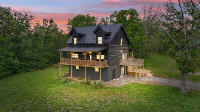 7868 Saint Clair Rd, Whitesburg, TN 37891 - back of house at dusk with a yard, a deck, and metal roof
