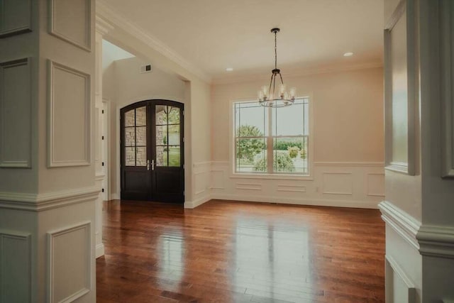 118 Luxury Ln, Dandridge, TN 37725 - unfurnished dining area featuring a chandelier, wood finished floors, a wainscoted wall, ornamental molding, and french doors