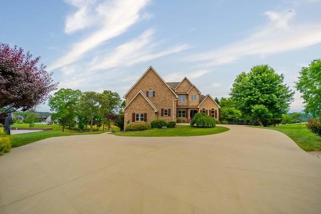118 Luxury Ln, Dandridge, TN 37725 - traditional home with a front yard, brick siding, and curved driveway