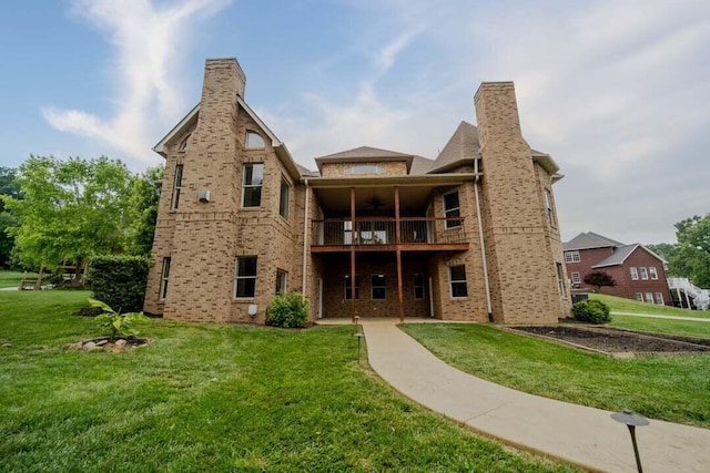 118 Luxury Ln, Dandridge, TN 37725 - back of house featuring ceiling fan, a balcony, a yard, and brick siding
