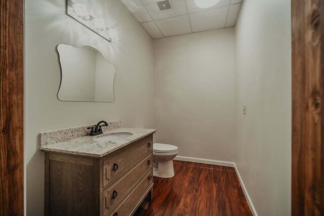 118 Luxury Ln, Dandridge, TN 37725 - half bathroom featuring a drop ceiling, vanity, toilet, baseboards, and wood finished floors