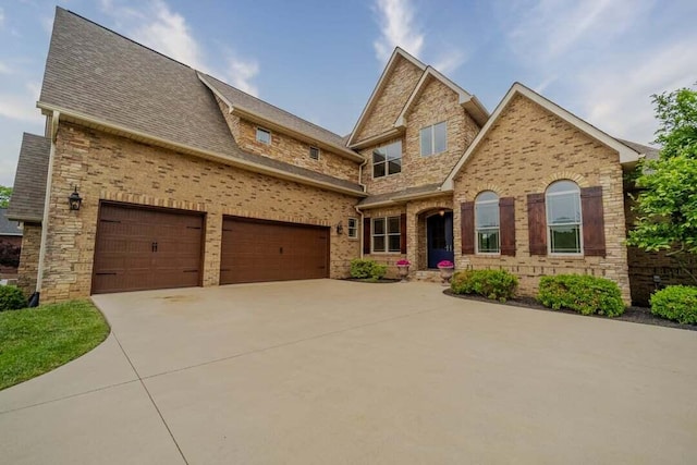 118 Luxury Ln, Dandridge, TN 37725 - view of front facade with concrete driveway, brick siding, and a shingled roof