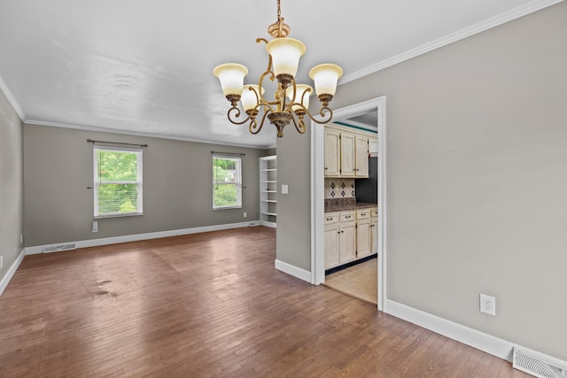 5715 Academy Dr, Morristown, TN 37814 - unfurnished dining area with ornamental molding, a chandelier, hardwood / wood-style floors, and baseboards